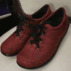 Pair of red leather lace-up shoes.