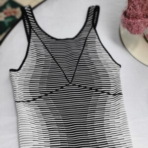 Striped black and white sleeveless top with a V-shaped design.