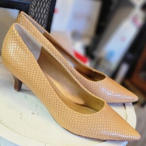 Elegant tan snakeskin-patterned kitten heel shoes on a white surface.
