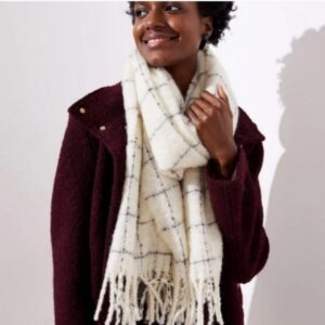 Person wearing a burgundy coat and a white checkered scarf.