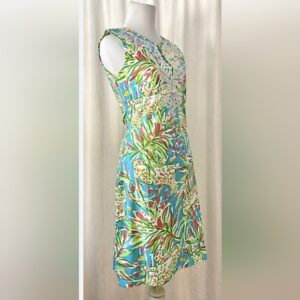 Colorful sleeveless dress with intricate floral and abstract patterns on a mannequin.