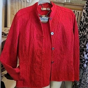 Red textured jacket on display mannequin.