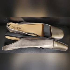 Elegant metallic silver slingback shoes with a modest heel.