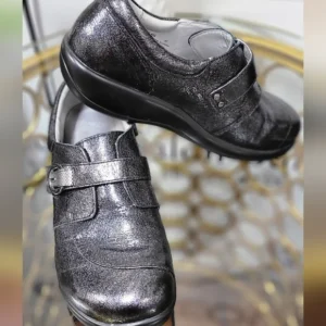 Pair of black leather dress shoes with laces and a buckle detail.