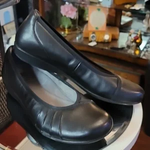 Pair of black leather women's shoes with a slight heel.