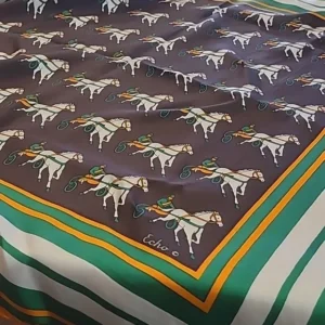 A patterned fabric featuring horses and green-striped borders.