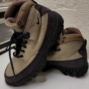 Pair of beige and brown hiking boots with black soles and laces.