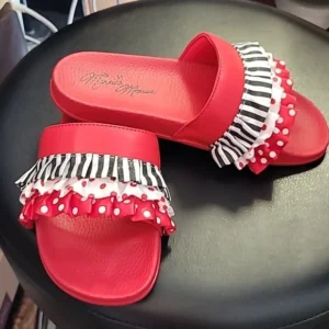 Red slide sandals with zebra and polka dot ruffles on top.